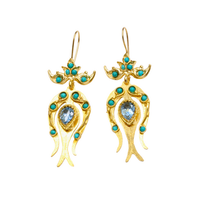 Gold earrings with turquoise stones on a white background